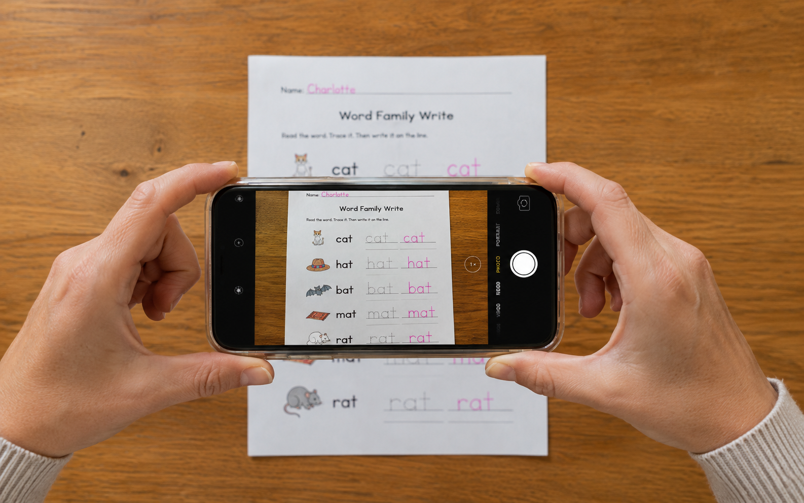 A parent photographing a completed worksheet with a phone